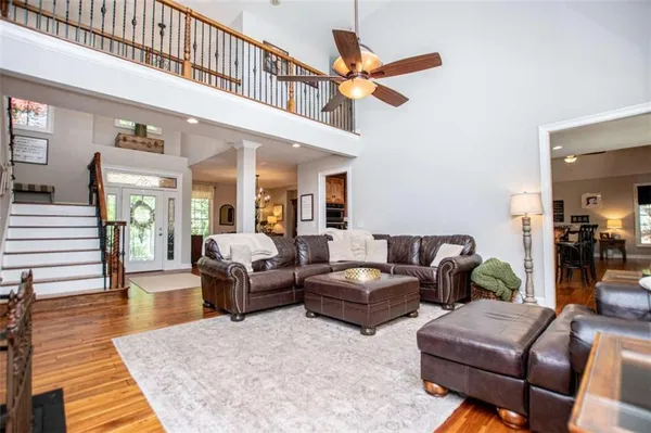 a kitchen with stainless steel appliances granite countertop a sink and cabinets with wooden floor