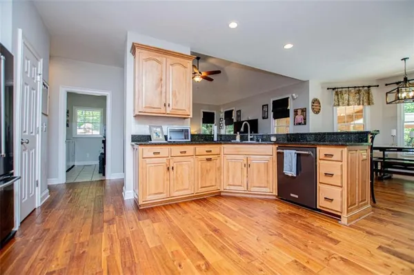 a bedroom with furniture a flat screen tv and a ceiling fan