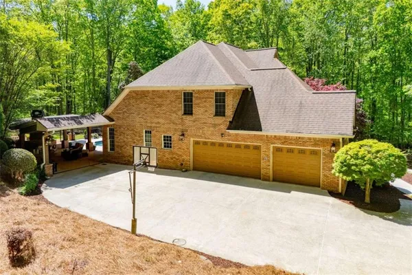 a aerial view of a house with large trees