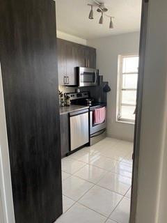 4174 Inverrary Drive, Unit 1015 Lauderhill, FL 33319 - Photo 2 of 15 a kitchen with stainless steel appliances granite countertop a refrigerator and a sink