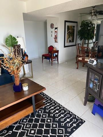 4174 Inverrary Drive, Unit 1015 Lauderhill, FL 33319 - Photo 6 of 15 a living room with furniture and a table