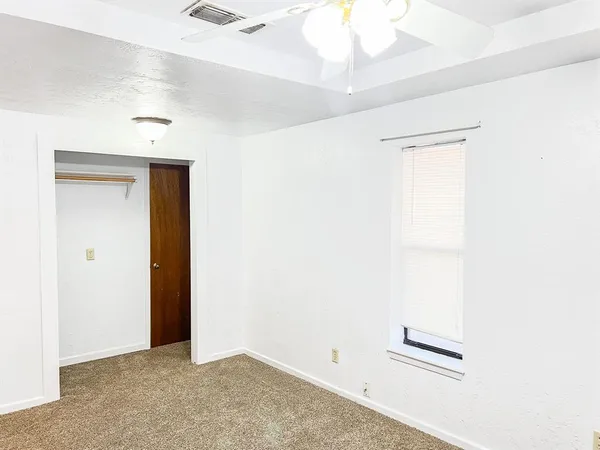 a kitchen with stainless steel appliances granite countertop a sink a stove a refrigerator a washer dryer and white cabinets