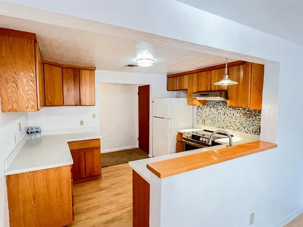 a stove top oven sitting inside of a kitchen