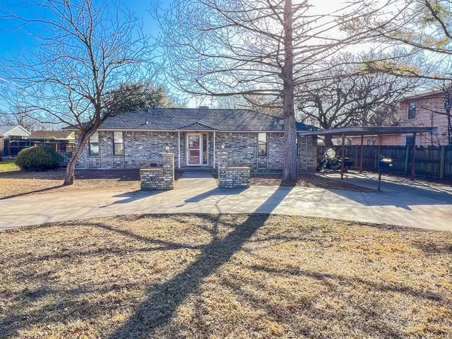 a view of a house with a yard covered in snow