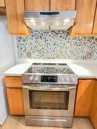 a view of an empty room with window and fire place