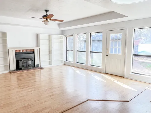 a view of a kitchen with a refrigerator cabinets and a wooden floor