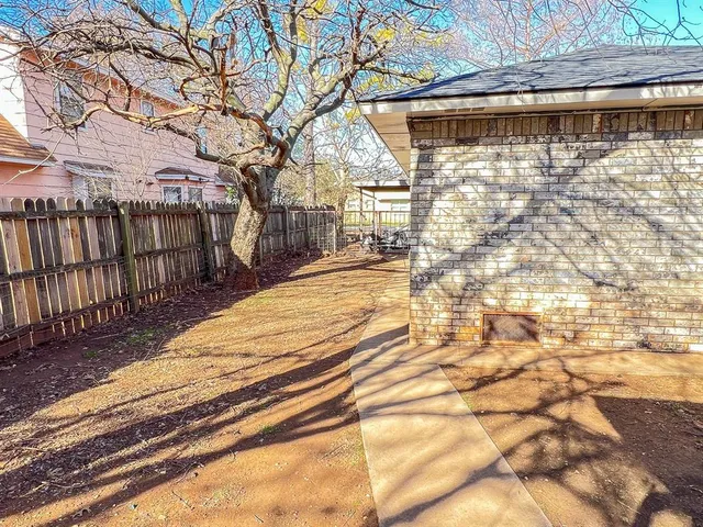 a house that has a tree in front of the house