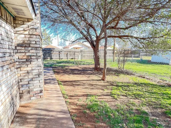 a view of balcony with wooden floor and fence