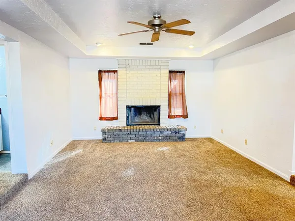 a view of empty room with fireplace