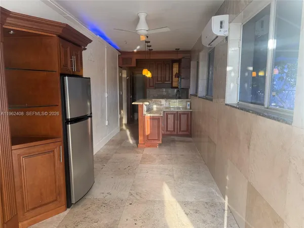 a bathroom with a granite countertop sink and a washing machine