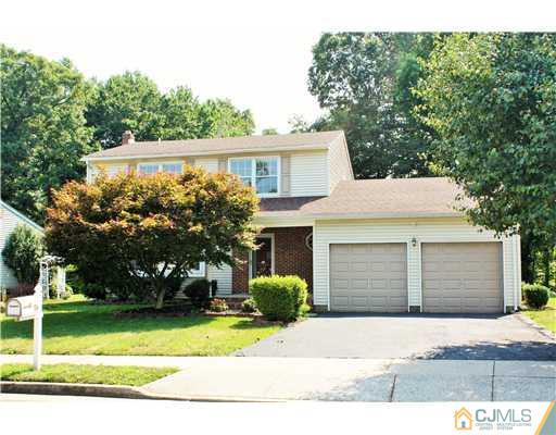 26 Ridge Road Edison, NJ 08817 - Photo 1 of 23 a front view of a house with a yard and garage