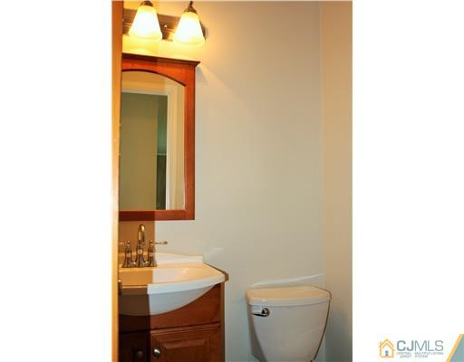 26 Ridge Road Edison, NJ 08817 - Photo 11 of 23 a bathroom with a toilet sink and mirror