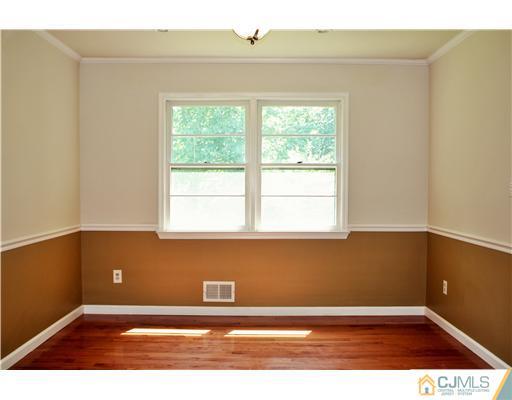 26 Ridge Road Edison, NJ 08817 - Photo 4 of 23 a view of an empty room with wooden floor and a window