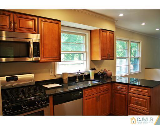 26 Ridge Road Edison, NJ 08817 - Photo 5 of 23 a kitchen with stainless steel appliances a sink stove and microwave