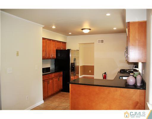 26 Ridge Road Edison, NJ 08817 - Photo 7 of 23 a kitchen with stainless steel appliances granite countertop a refrigerator and a stove