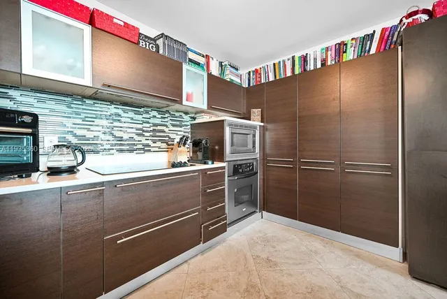 a kitchen with stainless steel appliances and countertop refrigerator