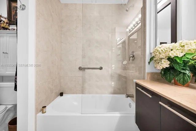 a bathroom with a sink a toilet and mirror