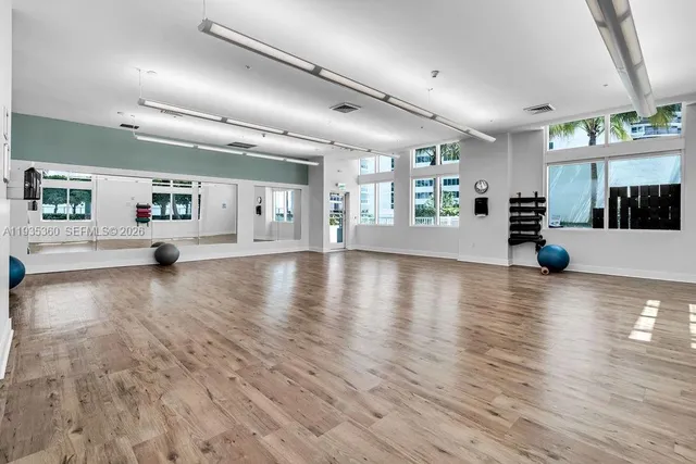 a view of a swimming pool with a bench and trees