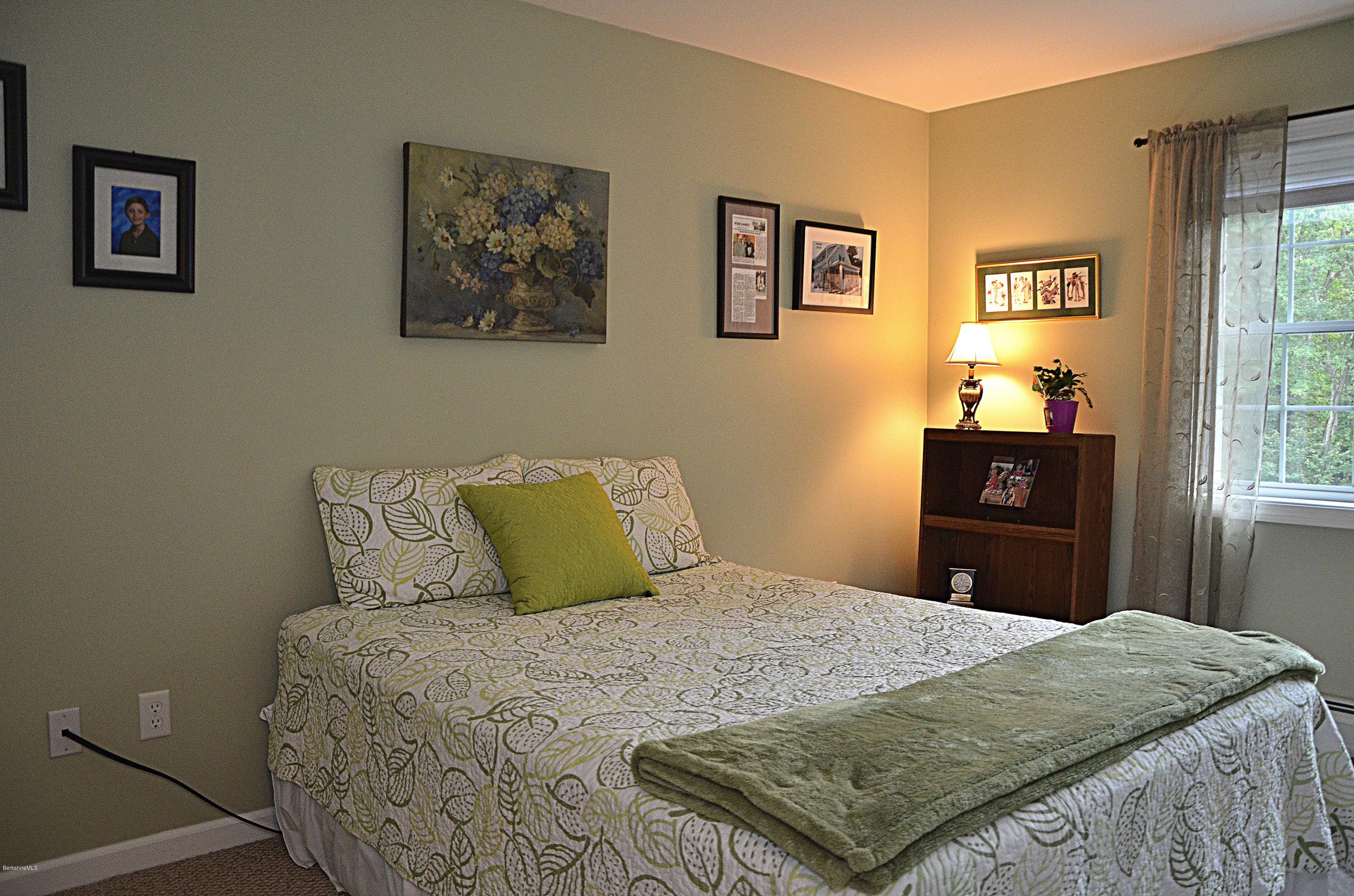 735 Upper Valley Road Washington, MA 01223 - Photo 22 of 33 a bedroom with a bed and wooden floor