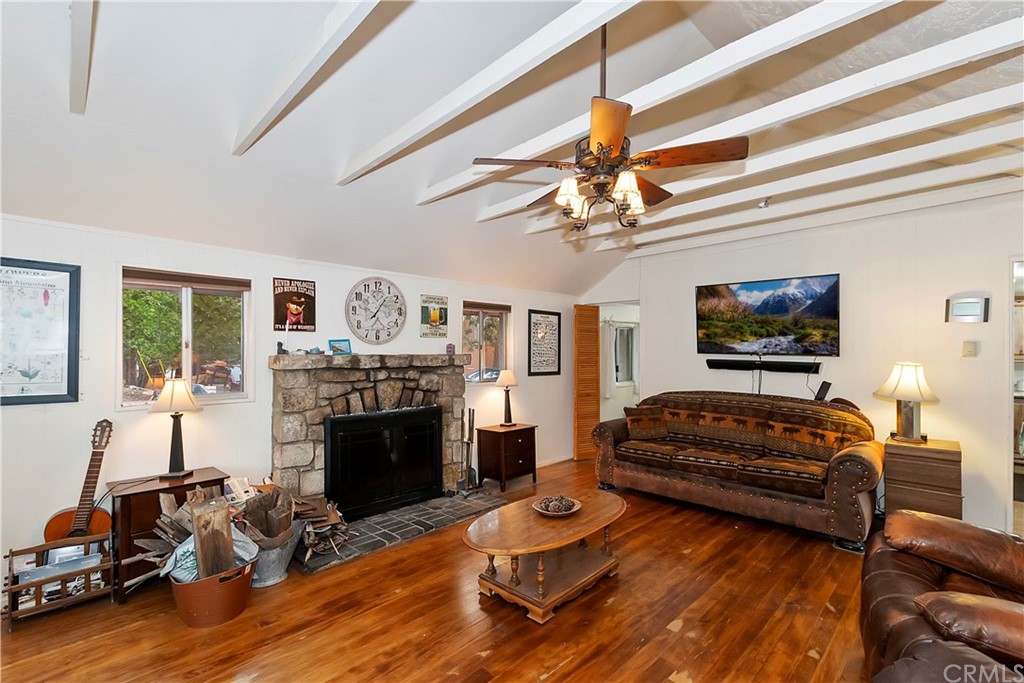 1211 Bridal Path Rimforest, CA 92378 - Photo 13 of 28 a living room with furniture a fireplace and a flat screen tv