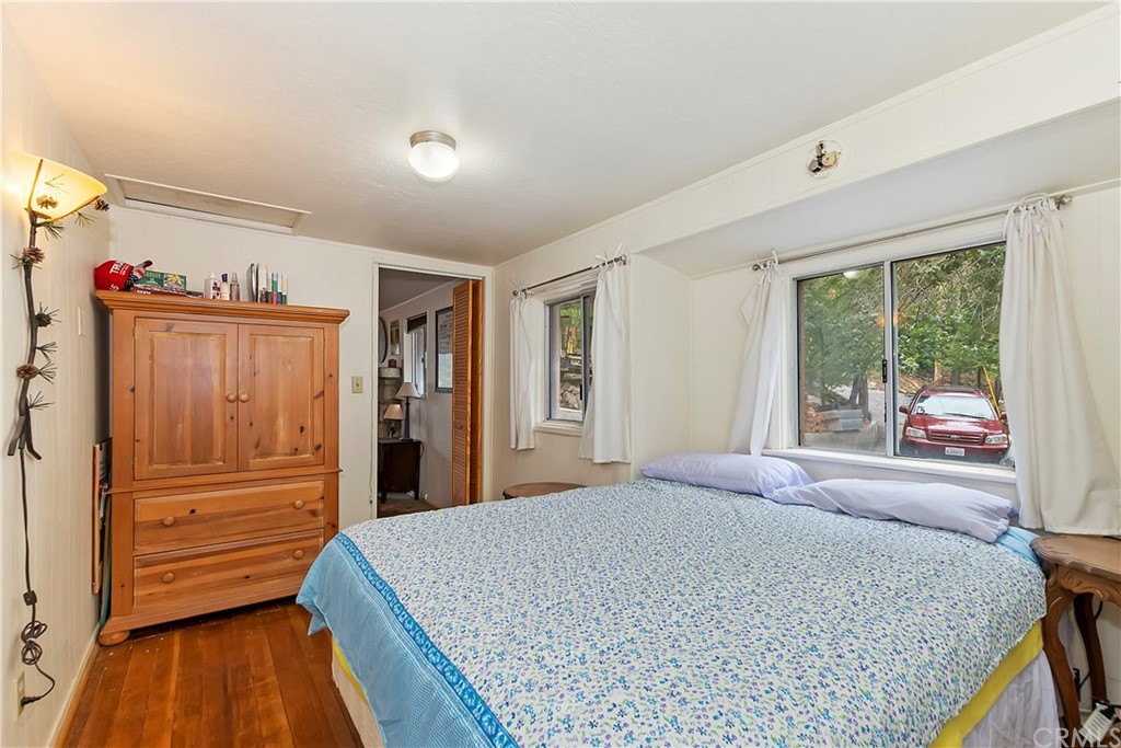 1211 Bridal Path Rimforest, CA 92378 - Photo 18 of 28 a bed room with a bed and a window