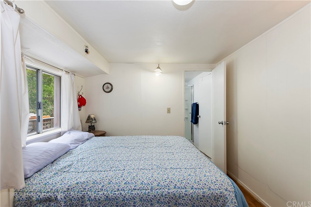 1211 Bridal Path Rimforest, CA 92378 - Photo 19 of 28 a bedroom with a bed and a large window