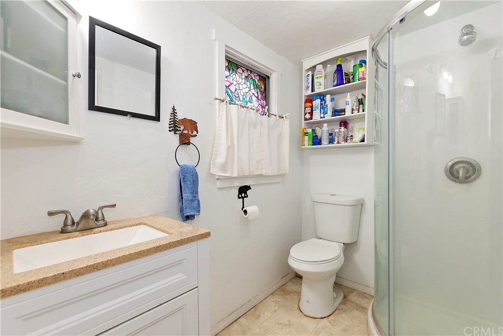 1211 Bridal Path Rimforest, CA 92378 - Photo 20 of 28 a bathroom with a toilet sink and mirror