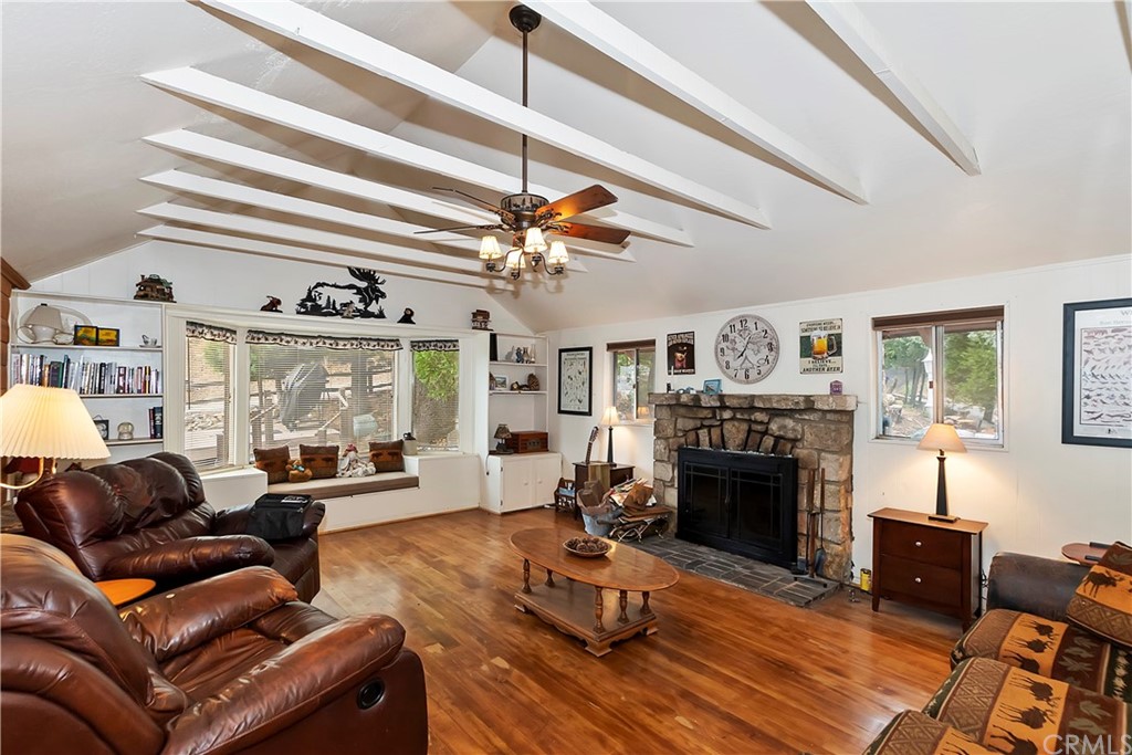 1211 Bridal Path Rimforest, CA 92378 - Photo 3 of 28 a living room with furniture a fireplace and a chandelier