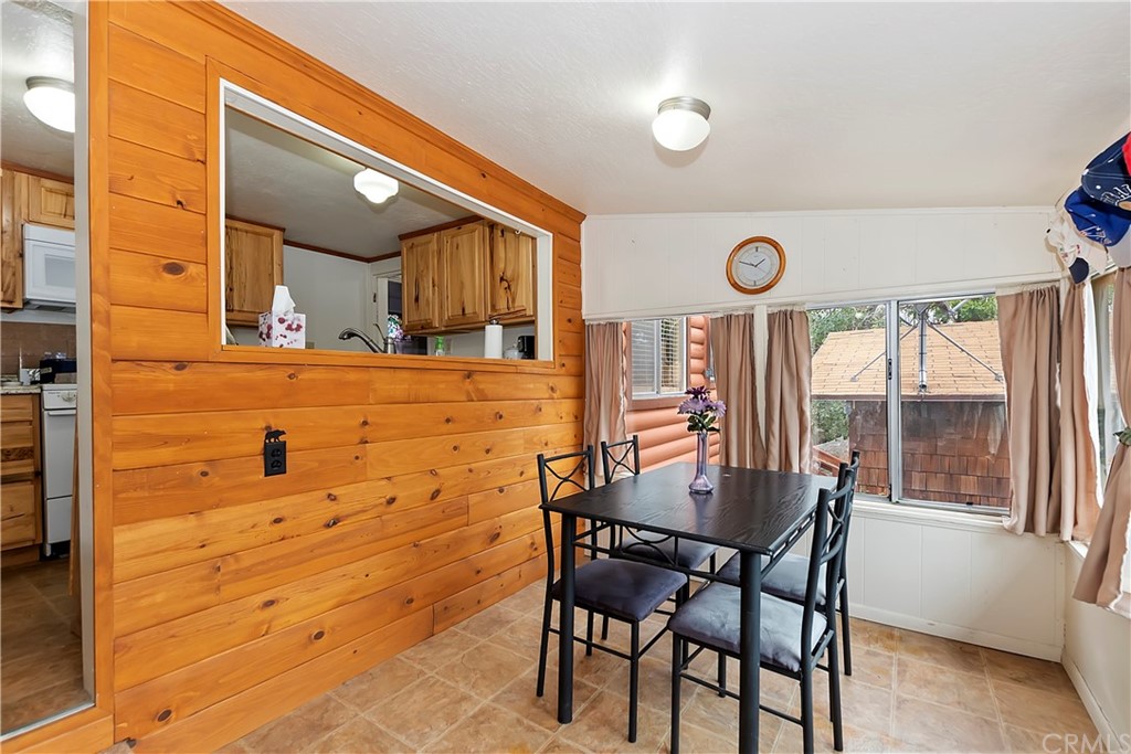 1211 Bridal Path Rimforest, CA 92378 - Photo 9 of 28 a view of a dining room with furniture and a window