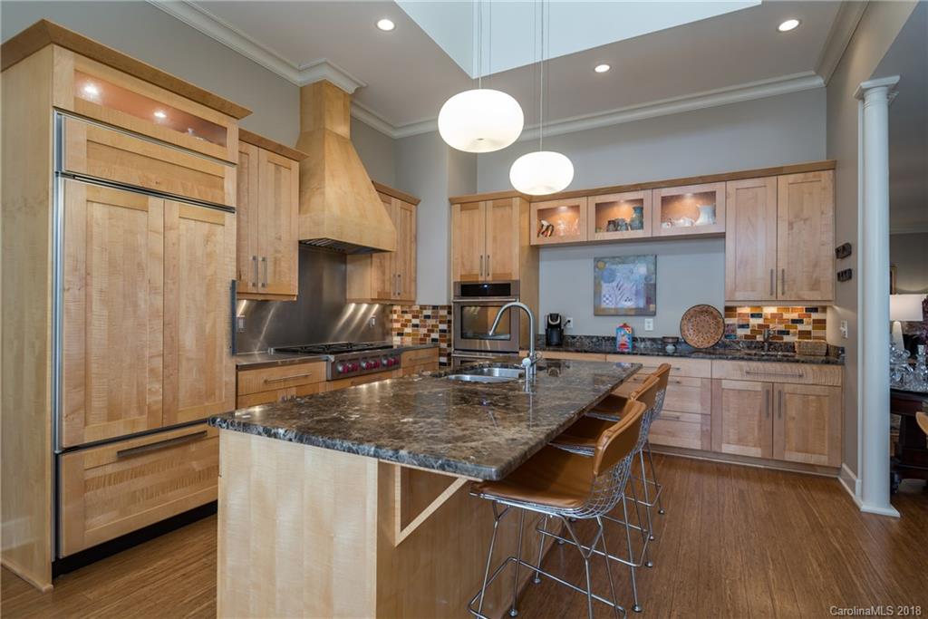 485 North Campbell Road Landrum, SC 29356 - Photo 9 of 22 a kitchen with a refrigerator a sink cabinets and wooden floor