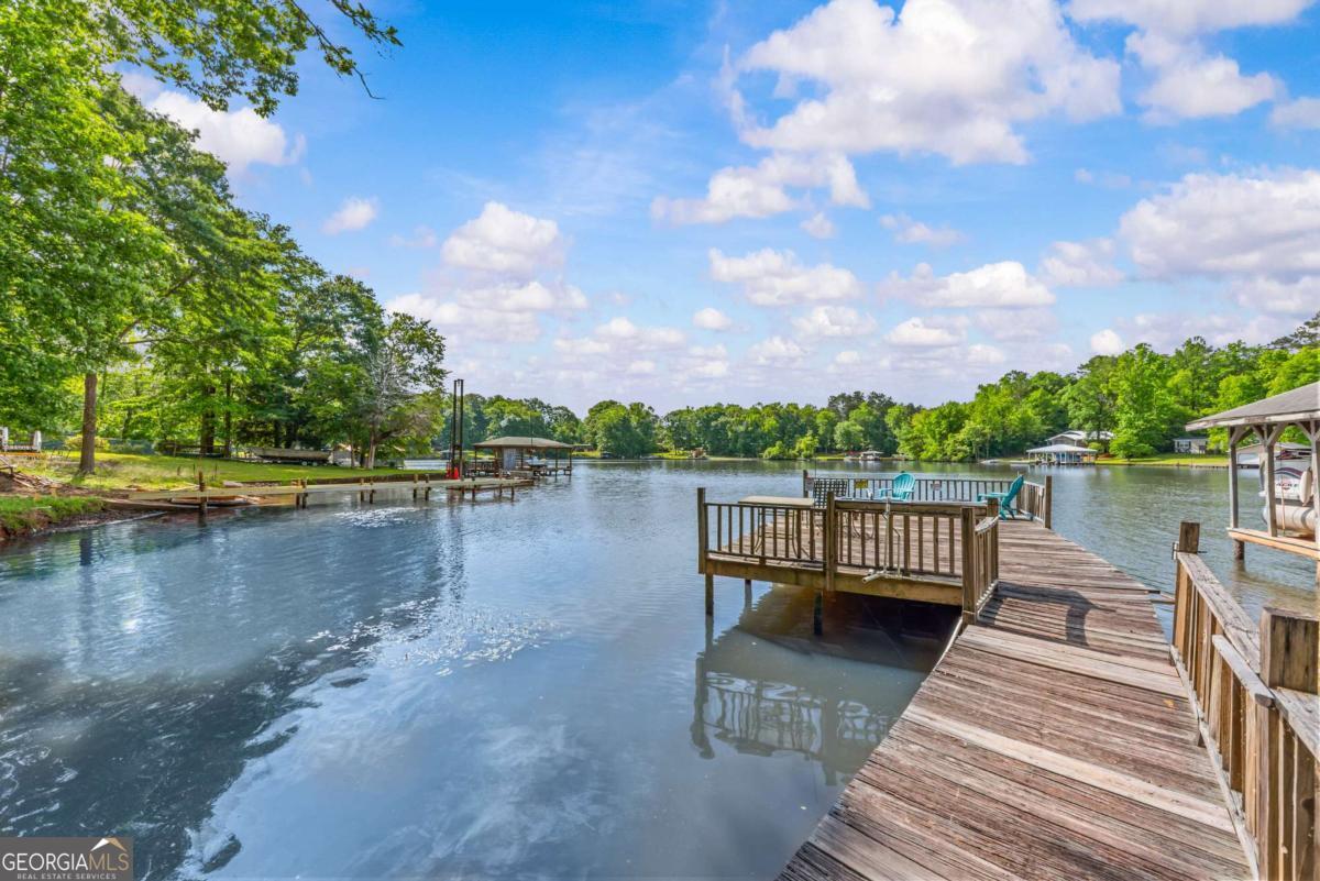194 Phillips Road Eatonton, GA 31024 - Photo 47 of 57 a view of a lake with deck and a yard