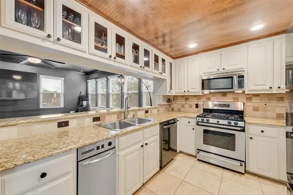 a kitchen with stainless steel appliances granite countertop a stove and a sink
