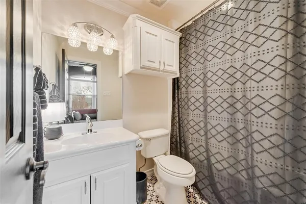 a bathroom with a sink a toilet and shower curtain