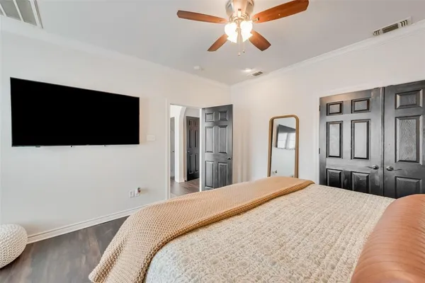 a bedroom with a bed and a flat screen tv