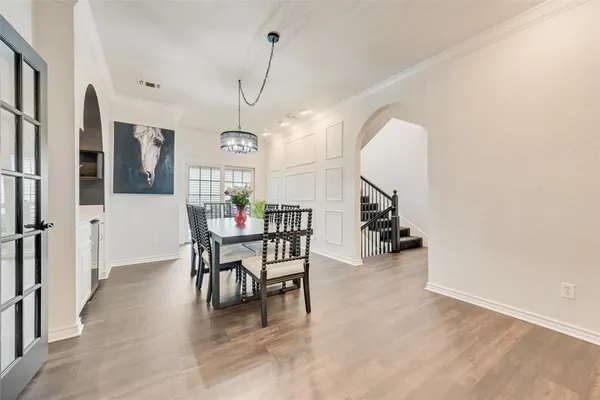 a view of a dining room with furniture and a chandelier