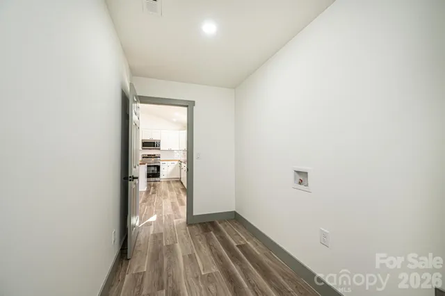 a bathroom with a granite countertop sink toilet a mirror and bathtub