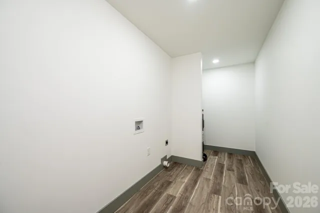 a spacious bathroom with a toilet a sink and a mirror