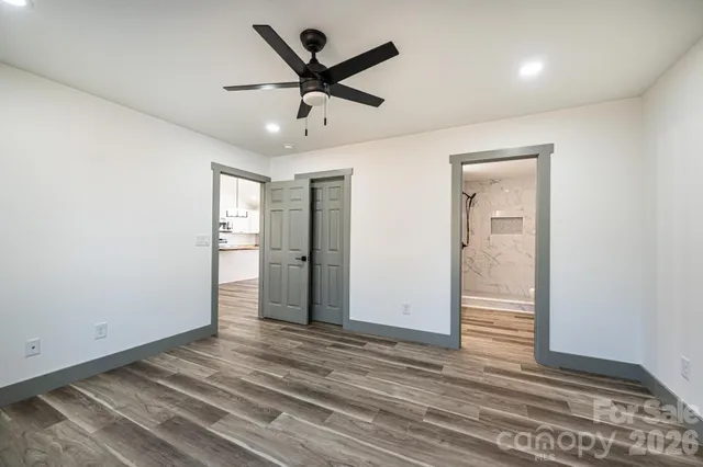 a view of a room with wooden floor and window