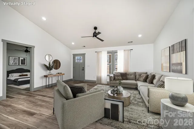 a open kitchen with kitchen island stainless steel appliances granite countertop stove and wooden floor
