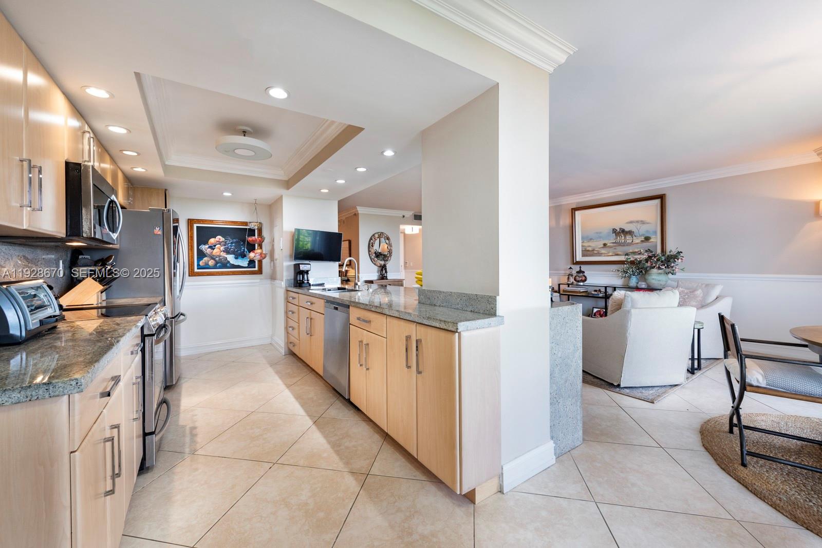 a large kitchen with stainless steel appliances granite countertop a stove and a refrigerator