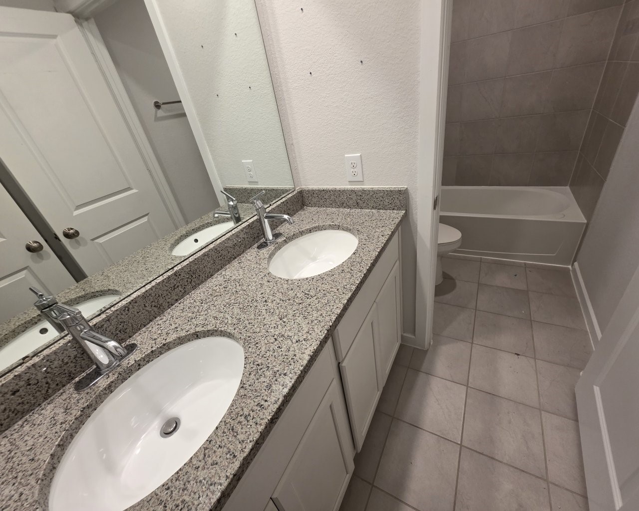 396 Weimer Lagoon Road La Porte, TX 77571 - Photo 20 of 25 a bathroom with a granite countertop sink a mirror and a bathtub