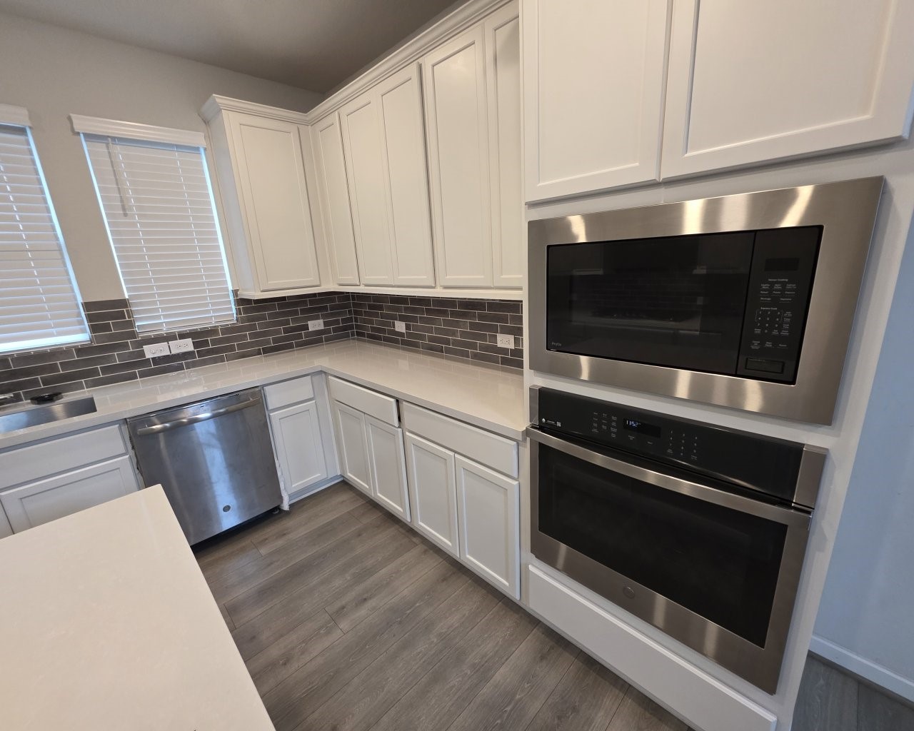 396 Weimer Lagoon Road La Porte, TX 77571 - Photo 5 of 25 a kitchen with stainless steel appliances a stove microwave and sink