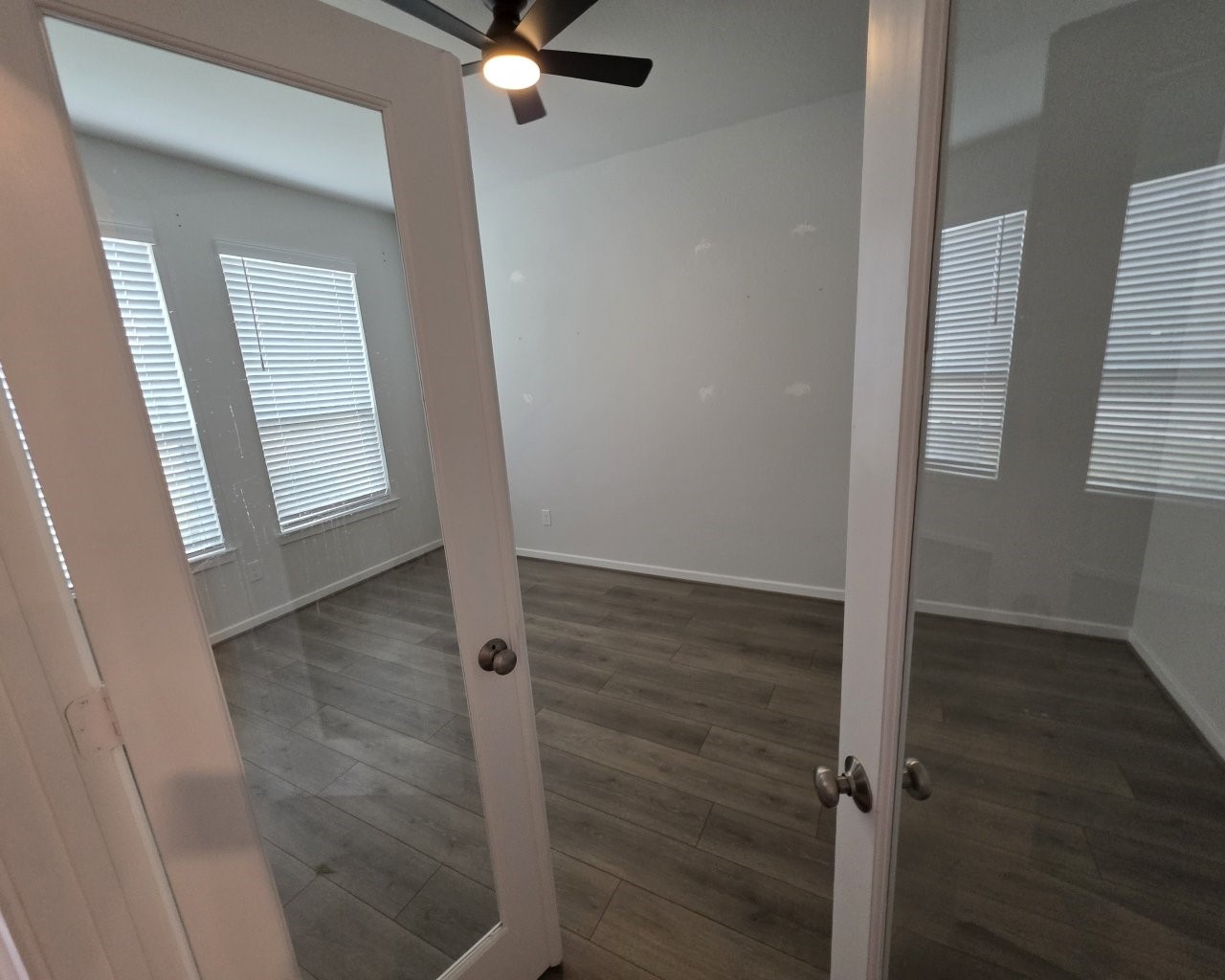 396 Weimer Lagoon Road La Porte, TX 77571 - Photo 9 of 25 an empty room with wooden floor cabinet and mirror