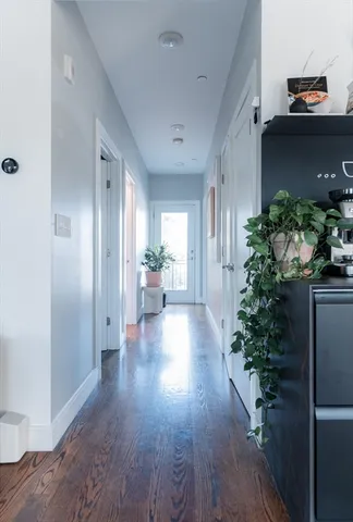 a view of a hallway with wooden floor