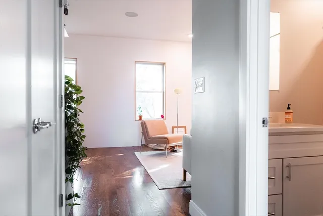 a view of a small space with wooden floor and a potted plant