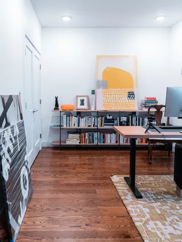 a living room with furniture and a mirror