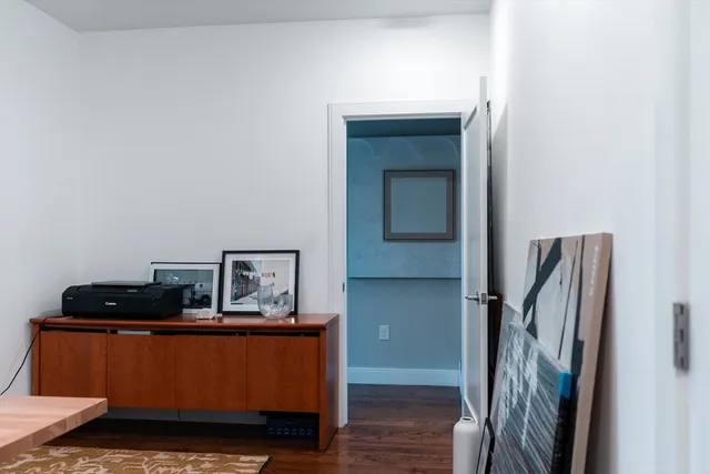 a view of a workspace with furniture and a potted plant