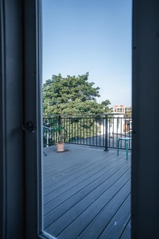 a balcony with wooden floor and outdoor space