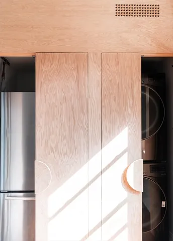 a metallic refrigerator freezer sitting in a kitchen