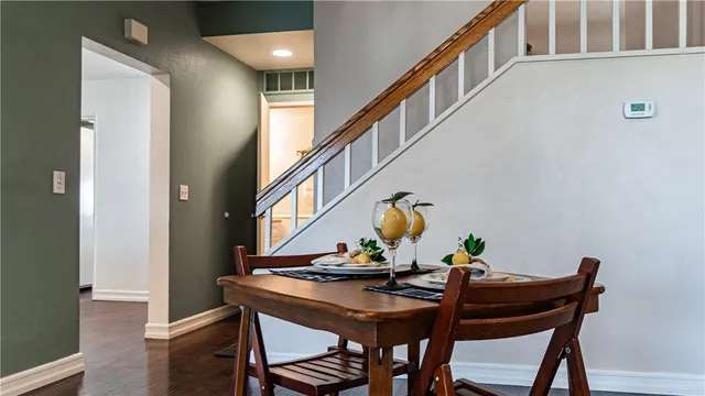 a view of a room with furniture and wooden floor
